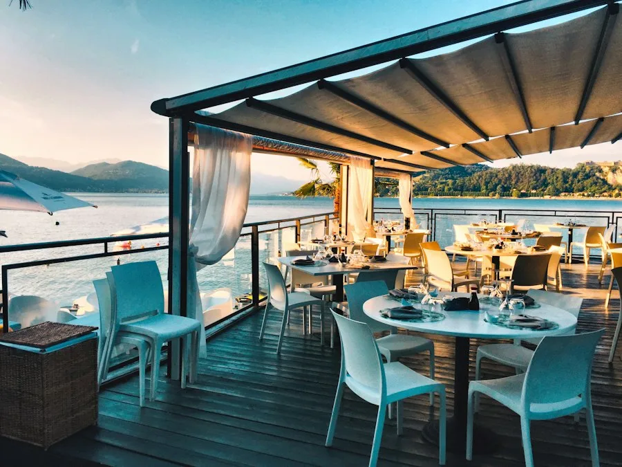 An open-air restaurant terrace overlooking the water